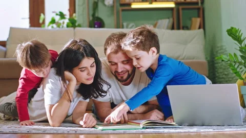 Fun time together for a family while stay at home laying down on the floor Stock Footage 135400072