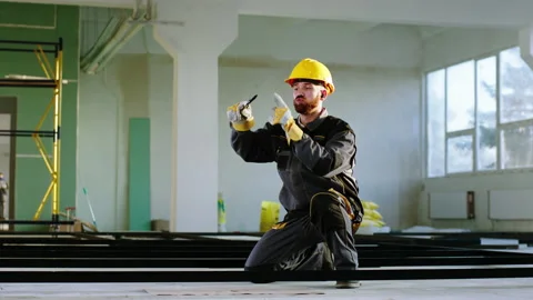 Fun time at work at construction site young guy in the special uniform and Stock Footage 170147460