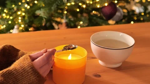 Fun tin casting set for New Years .Spoon with tin over candle flame Stock Footage 321653048