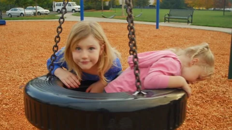 Fun with a tire swing Stock Footage 58636874