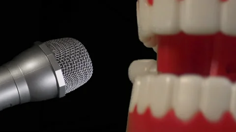A fun toy joke set of chatty teeth chattering or singing into a microphone. Stock Footage 239342620