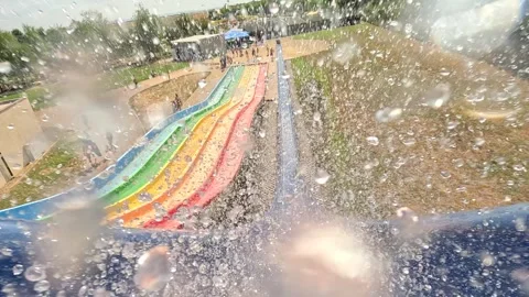 Fun on the water slide in aqua park, slow motion Stock Footage 282372005