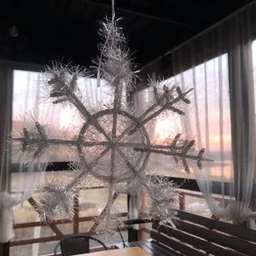 Fun Winter decorative snowflake on sunset background Foto stock