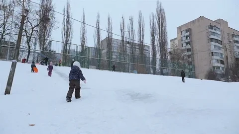 Fun on a winter hill with snow. Slow motion 01.10.2020 Ukraine, Kiev Stock Footage 126652656