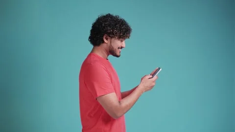 Fun young bearded multi-ethnic man 20s years old hold in hand use mobile cell Stock Footage 261738595