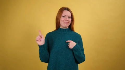 Fun young woman looking at camera and pointing fingers herself ask say who me no Stock Footage 148492115