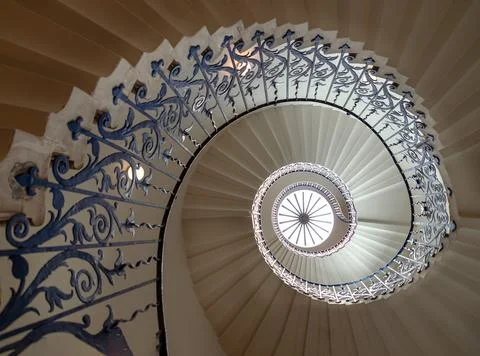A functional spiral staircase into a hypnotic, shell-like geometry. White s.. Stock Photos