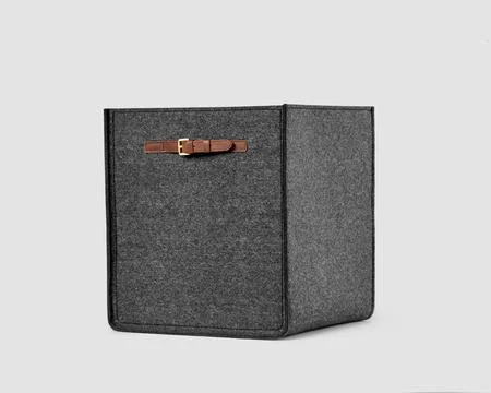 Functional storage basket of gray felt with sewn-on leather handles 写真素材