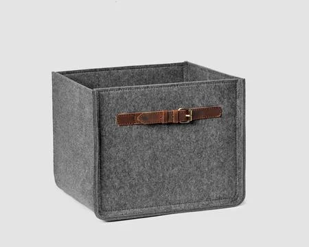 Functional storage box of natural gray felt with leather handles 写真素材