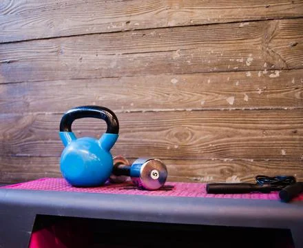 Functional training concept. Kettlebell, dumbbell, jump rope stand on a fitne Foto stock