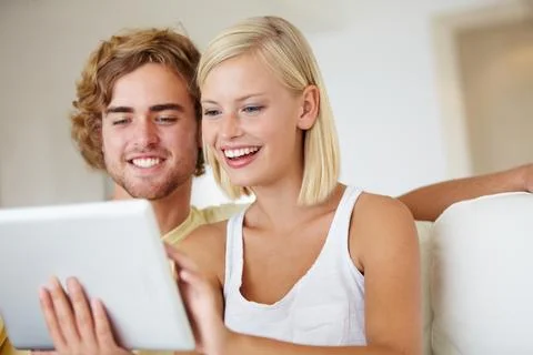 Functionality for everyone. A happy young couple using a tablet together in 写真素材