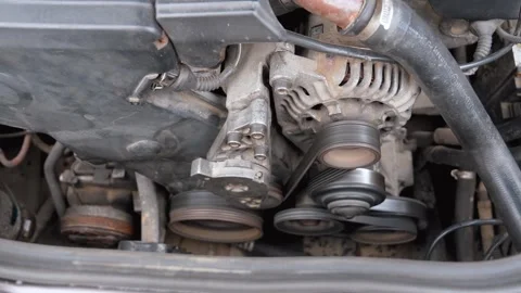 Functioning car engine serpentine belt and alternator Stock Footage 327664414