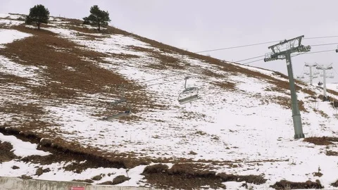 Functioning chairlift in mountains above slope. Slope without snow Stock Footage 102482725