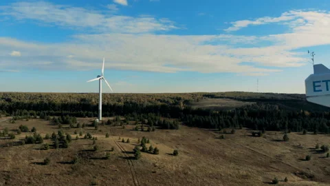 Functioning windmills, wind energy turbines installed in the open terrain. Green 動画素材 98488267