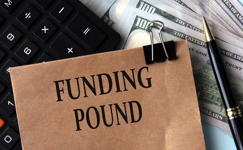 FUNDING POUND - words on brown paper on the background of calculator and ba.. Stock Photos