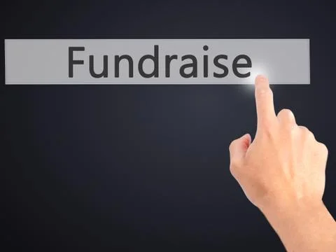 Fundraise - Hand pressing a button on blurred background concept on visual sc Stock Photos