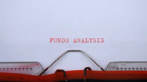 Funds analysis - phrase printed on an old typewriter in red letters, close up. 動画素材 129535726