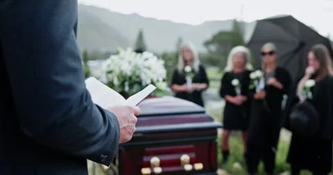 Funeral, hands or priest with bible at graveyard, memorial service or scripture Видео 330919088