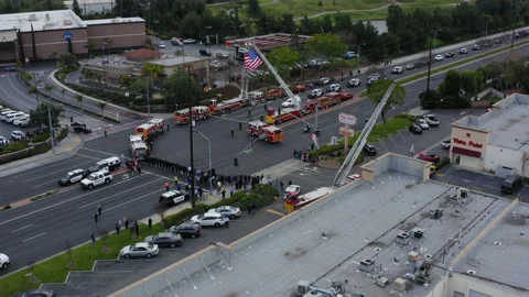A funeral procession drives through town, honoring the death of a police Stock-Footage 172550334