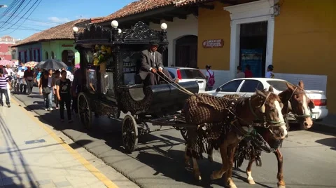 Funeral procession marches down narrow street in Granada, Nicaragua. Stock Footage 67390321