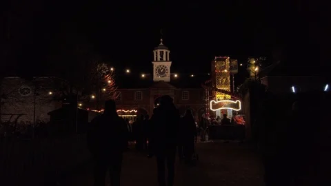Funfair fairground at night with clock tower in background all lit up and Stock Footage 123904567