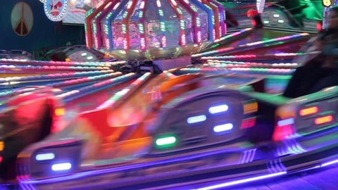 Funfair fairground ride bokeh lights moving people night Stock Footage 100715349