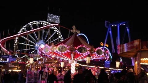Funfair fairground ride bokeh lights moving people night Stock Footage 100717984