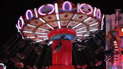 Funfair fairground ride bokeh lights moving people night Stock Footage 100718116