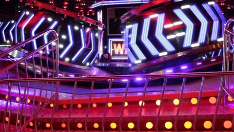 Funfair fairground ride waltzer lights moving people night Stock Footage 100715018