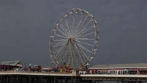 Funfair ferris big wheel pier stormy sky Stock Footage 74266671