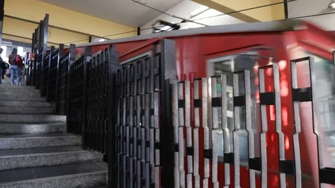 Funicular arriving at the upper station behind the protective grating Stock Footage 109277999