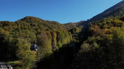 Funicular cabins moving on the cableway. autumn landscape. forest-capped Stock Footage 204011023