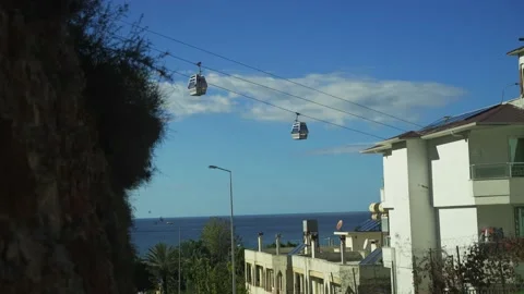 Funicular to the mountains against the backdrop of the city and the blue sea Stock Footage 239545915