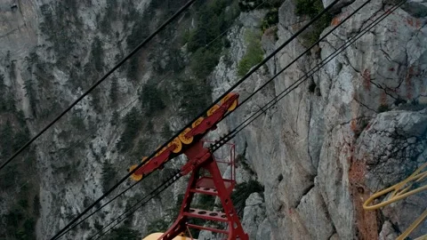  funicular in operation. Yellow cabin moves up cable car over cliffs Stock Footage 171787407