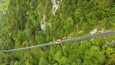 Funicular railcar going down from tourist center on the  mountain to the town Stock Footage 95116676