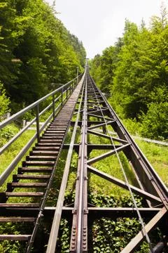 The funicular rises up in the mountains by rail Stock Photos