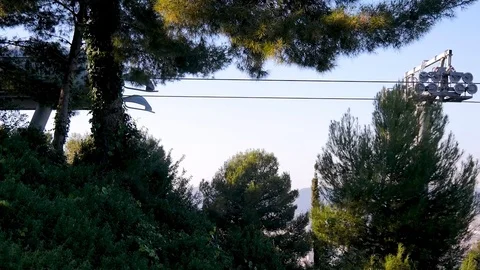 The funicular with tourists is approaching the base amid green trees and plants Stock Footage 101099810