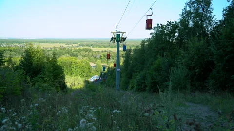 Funiculars descend on a cable, the camera rises from the grass Stock Footage 158445014