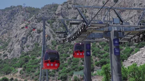 Funiculars move along the cable car on the backdrop of mountains Stock Footage 208949267