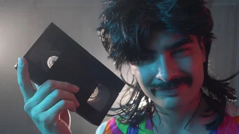 Funky 80s 90s Mustache Man Holding a VHS... | Stock Video | Pond5