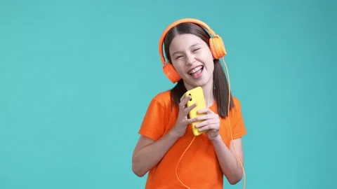 Funky crazy schoolkid listen headset gadget pop isolated cyan color background Stock Footage 190180852