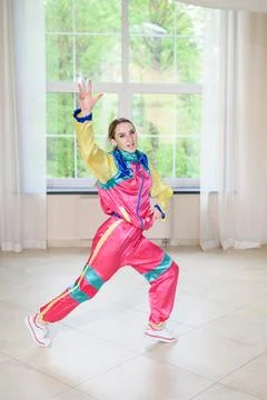 Funky dance workout. Young athletic woman dancing in stage costume in jazz funk Stock Photos