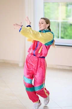 Funky dance workout. Young athletic woman dancing in stage costume in jazz funk Stock Photos