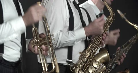 Funky jazz performance by three men with saxophones and a trombone, 4k Stock Footage 229247656
