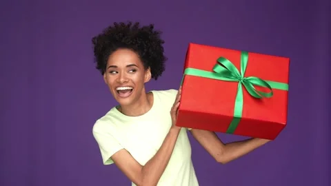 Funky lady hold big gift shake dream cuddle isolated violet color background Stock Footage 165879709