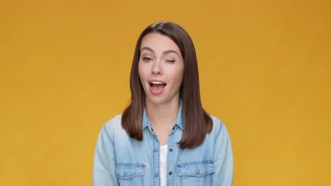 Funky lady wink eye feedback choice isolated mustard beige color background Stock Footage 166449272