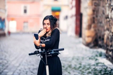 Funky woman making faces while looking at camera. Young woman taking photographs Stock Photos