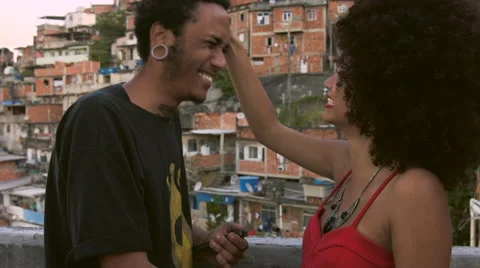 A funky young couple talking to each other on terrace Stock Footage 61292246