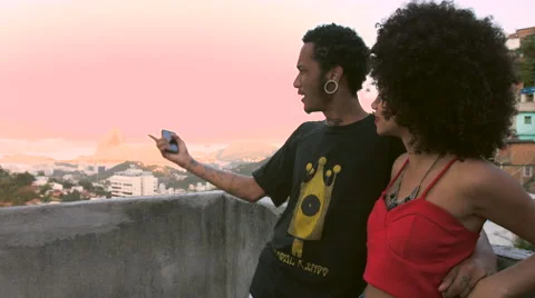 A funky young couple talking to each other on terrace Stock Footage 61292254