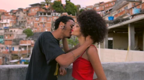 A funky young couple talking to each other on terrace Stock Footage 61292255